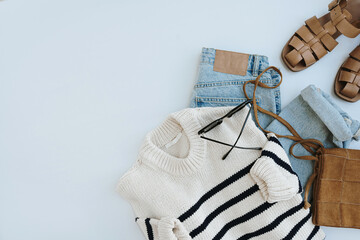Aesthetic casual fashion composition with female clothes and accessories. Striped sweater, leather...