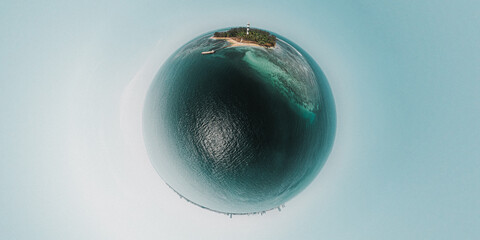 A perfect blue sphere  island sits in a studio, isolated against the darkness of its background. Isla de Sacrificios, Veracruz.
