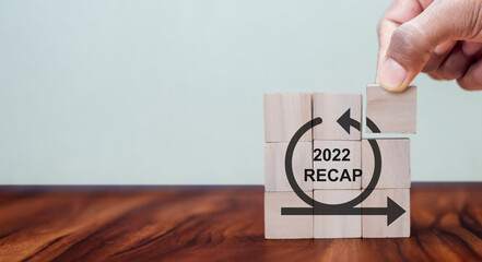 2022 Recap economy, business, financial concept. For business planning. RECAP word icon on wooden...
