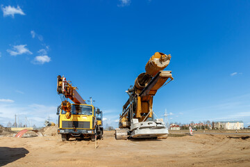 The construction site for the highway with heavy equipment. Two rotational exercises, lifting crane