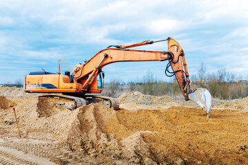 Excavator dig the trenches at a construction site. Trench for laying external sewer pipes. Sewage...