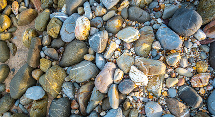 .amazing to see on the beach is full of round rocks instead of sand. .round rocks have beautiful color and various size. .rocks beach at the lighthouse landmark of Lanta island Krabi. stone background
