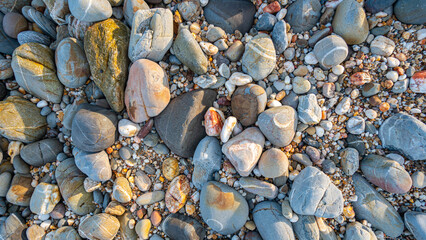 .amazing to see on the beach is full of round rocks instead of sand. .round rocks have beautiful color and various size. .rocks beach at the lighthouse landmark of Lanta island Krabi. stone background