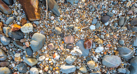 .amazing to see on the beach is full of round rocks instead of sand. .round rocks have beautiful color and various size. .rocks beach at the lighthouse landmark of Lanta island Krabi. stone background