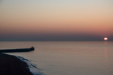 A dawn light behind Folkestone Harbour Arm