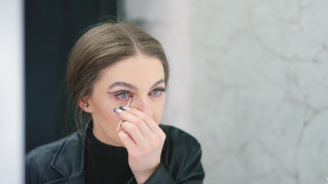 Woman retouching her make-up in a backstage