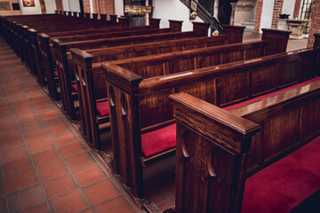 Obraz na płótnie Canvas Rows of church benches at the old european catholic church. 