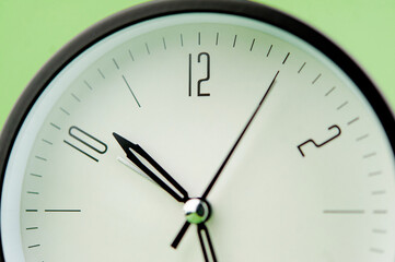 clock precious time alarm clock on green background concept of time working with time