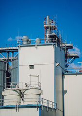 Modern silos for storing grain harvest at the blue sky background. 