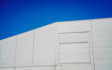 Modern big industrial warehouse buildings at the blue sky background. 