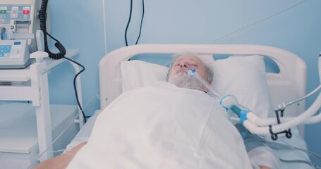 Sick ol patient has blood transfusion in hospital, patient with tube in mouth lying on bed at clinic. suffering from coronavirus, covid-19. man recovering from injury in hospital ward at medical unit - Powered by Adobe