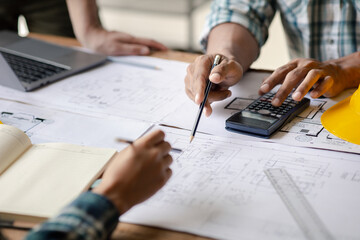 Architects and engineers are working together to edit the draft house plan that was designed after it was presented to the client and partially revised the design. Interior design and decoration ideas