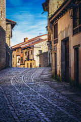 Fototapeta na wymiar Cobbled road in historic part of Santillana del Mar town, Cantabria region, Spain