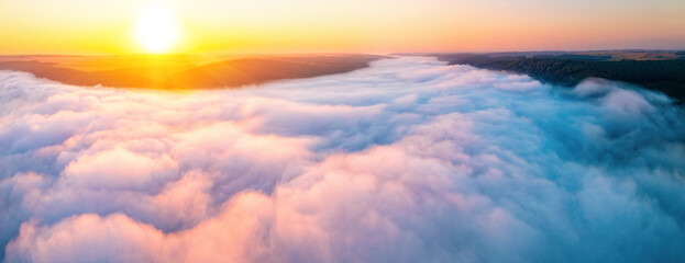 Fototapeta premium A fantastic bird's-eye view of the valley shrouded in thick fog.