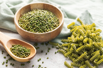 Mung bean fusilli pasta on a gray concrete background.