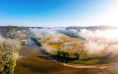 Landscape with a picturesque river flowing through green meadows. Dniester canyon national park, Ukraine, Europe.
