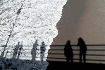 The shadow of some people on the beach