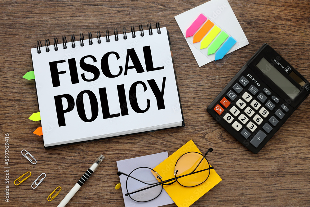 Poster fiscal policy text on notepad pages with tacky bookmarks and stickers. calculator and glasses
