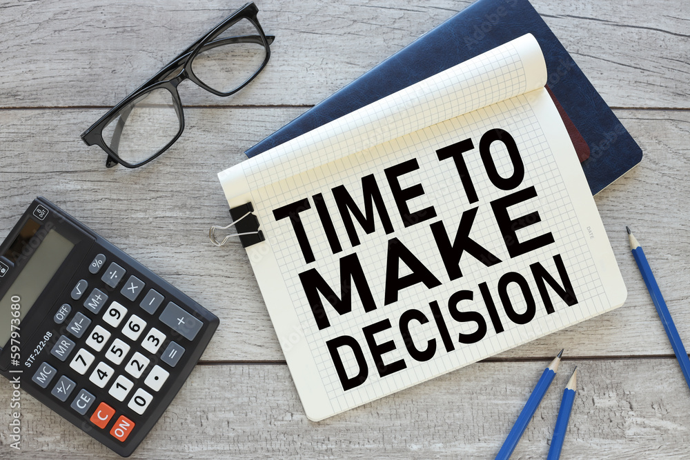 Poster time to make decision notepad with clip on blue notepad near calculator. text on the page