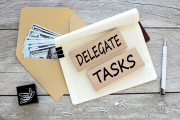 Delegate Tasks text on an envelope with money