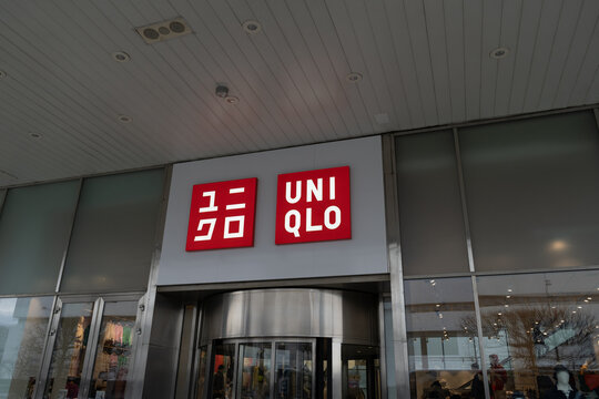 Uniqlo clothing store logo sign. Japanese casual wear brand and retailer shop signboard with logotype. Fashion shopping company from Japan on March 24, 2023 in Warsaw, Poland.
