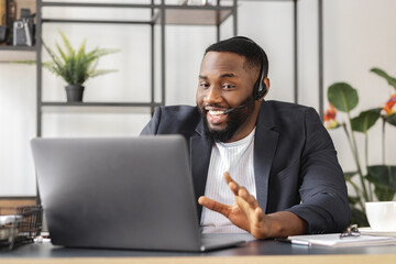 Male working remotely. Online interview between African American business man hr director and job candidate. Recruitment manager talking using laptop, hiring for job person sitting in office