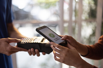 Female vase seller processes orders, including delivery payments, with smartphone and quick response code before sending items to customers. Small business owner work and coordinate with carrier.