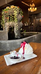 Milk Korean shaved ice with blueberry sauce and cheesecake