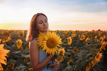 girls in a field of sunflowers at sunset. Ukraine . Family walking in the field, field of sunflowers, sunset in the field

