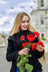 Girl with a bouquet of red tulips