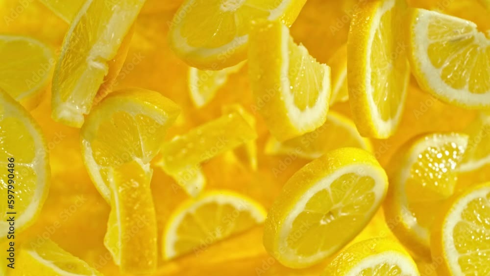 Poster super slow motion of flying lemon slices on black background. filmed on high speed cinema camera, 10