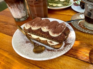 Tiramisu, Italian layered dessert with mascarpone cream, garnished with cocoa powder.