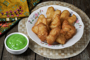 Youtiao or baby cakoi fried breadstick with pandan green sauce