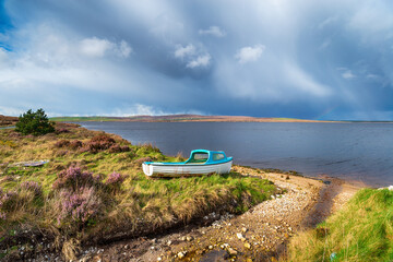 Fototapeta na wymiar A boat on the shores of Carrowmore Lake