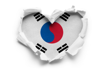 Heart shaped hole torn through paper, showing satin texture of flag of South Korea, cut out