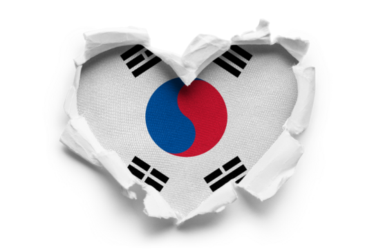 Heart shaped hole torn through paper, showing satin texture of flag of South Korea, cut out