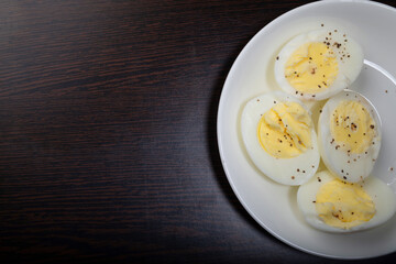 Boiled egg with seasoned black pepper in plate with text space