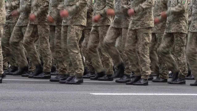 Military men marching in the parade. Soldiers legs. Boots forces and infantry soldier. Army march. Defender team. Crowd man go. Armed forces walking in a row. Pixel uniform. War background.