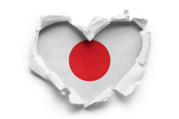 Heart shaped hole torn through paper, showing satin texture of flag of Japan, cut out