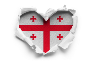 Heart shaped hole torn through paper, showing satin texture of flag of Georgia, cut out