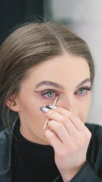 Woman retouching her make-up in a backstage