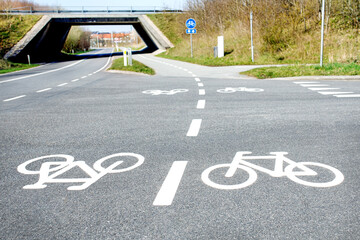 Fototapeta premium White cycling road markings across the road showing the continued movement of cyclists across the main road