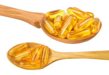 Fish oil capsules in wooden spoon isolated on white background with full depth of field. Top view. Flat lay