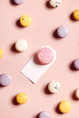 Fototapeta premium Holiday concept. card for invitation, anniversary , birthday party. frame, mockup copy space. colorful macaroons on beige background.