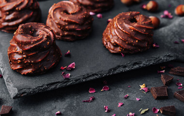 cakes in chocolate glaze on stone board