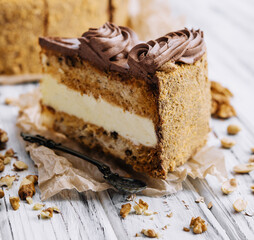 Chocolate, caramel, peanut cake on wood