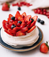 Plate with delicious strawberry cake on table