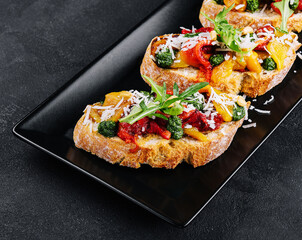 bruschetta with roasted peppers, pesto and parmesan cheese