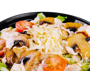 Warm salad with roasted chicken meat, vegetables and mushrooms