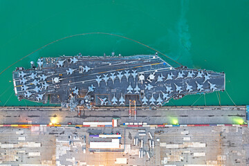 aerial view of Nuclear ship, Military navy ship carrier full loading fighter jet aircraft and helicopter patrol.